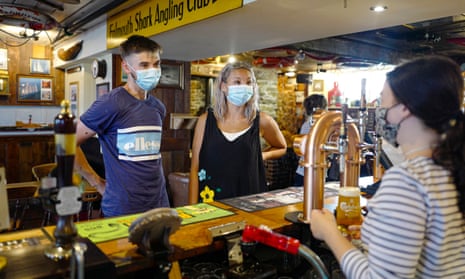 Sophie and Garrie from Tunbridge Wells, first customers to order from the bar at the Chainlocker pub in Falmouth on 19 July