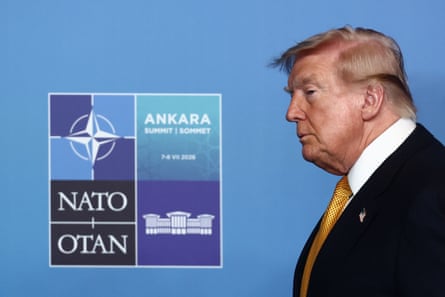 Donald Trump walking past signage that reads ‘Nato Ankara Summit’