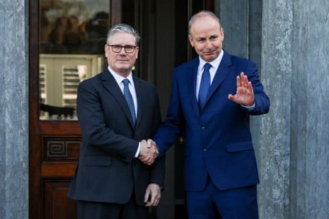 Keir Starmer shakes hands with Micheál Martin as they pose for photos.