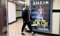 A man walks past a Shein advertisement in London.