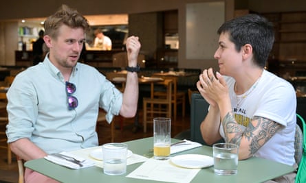 Two people sitting talking at a restaurant table