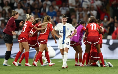 Finland's Natalia Kuikka looks dejected after the match as Switzerland players celebrate.