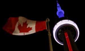 Toronto’s CN Tower is lit up in blue, white and red