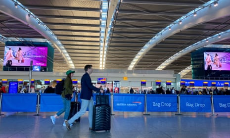 Passengers check-in in terminal 5 at Heathrow Airport, west London
