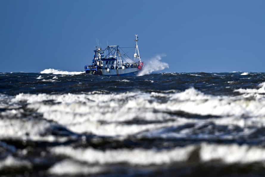 A fishing trawler as white-capped waves roll in