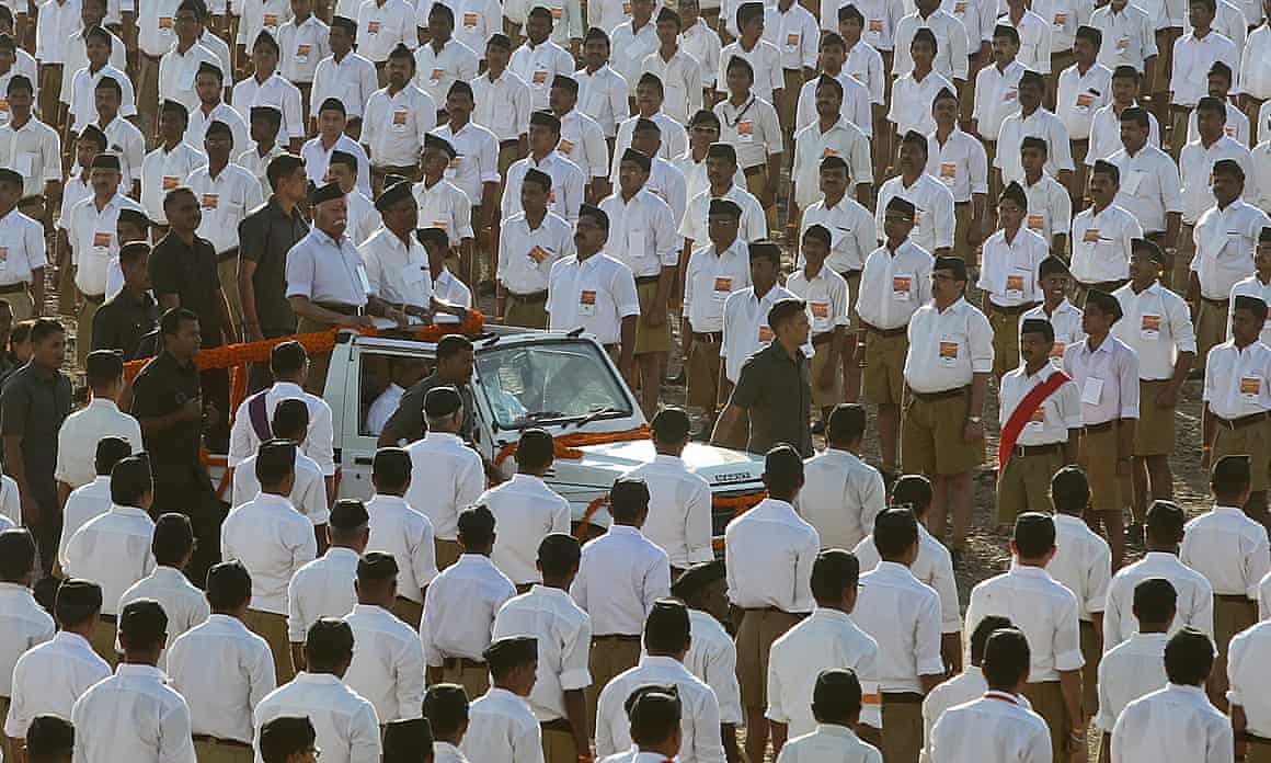 A man in a Jeep inspects lines of men standing in uniform