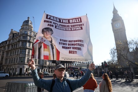 A supporter of assisted dying with a banner saying the legislation has majority support.