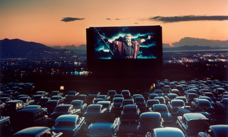 Actor Charlton Heston as Moses w. arms flung wide. UTAH, UNITED STATES - 1958: Actor Charlton Heston as Moses with arms flung wide appearing in motion picture The Ten Commandments as it is shown at drive-in movie theater.