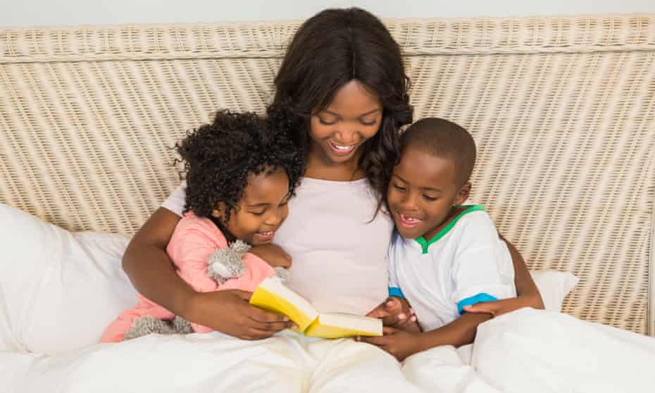 Mother and children reading book