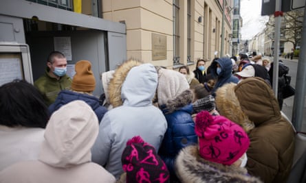 People from Ukraine, most of them refugees fleeing the war, wait in front of the consular department of the Ukrainian embassy in Berlin, Germany.