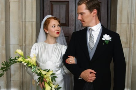 A smartly dressed couple, the woman holding a bouquet, being married in the early 20th century.