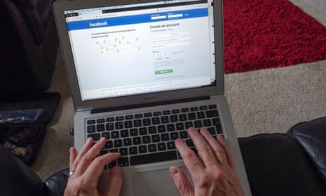 Man on laptop with Facebook home page
