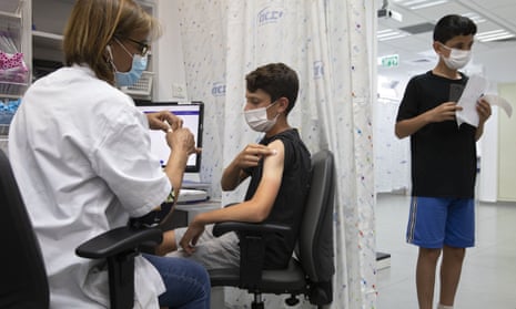 An Israeli youth receives a Pfizer vaccine in Rishon LeZion. Pfizer will expand its trial in under-12s.
