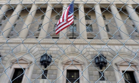 FILE PHOTO: A fence surrounds the U.S. Department of Commerce in Washington October 5, 2013, as the government shutdown continues into the weekend. REUTERS/Mike Theiler/File Photo