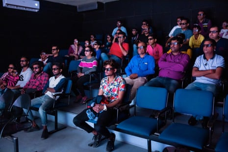 Visitors gather for an informational video in an air-conditioned room of the Nehru Planetarium in Delhi. India, 2019