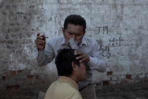 Emerson Mejia Cruz, 43, has his head blown with tobacco smoke