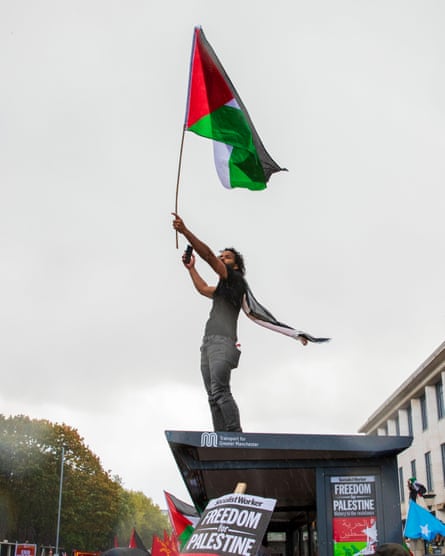 A protester waves a Palestinian flag in Manchester.