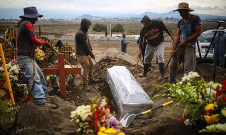 Workers of the San Miguel Xico cementery bury a coffin of a presumed Covid-19 victim on 24 June 2020 in Valle de Chalco, Mexico.