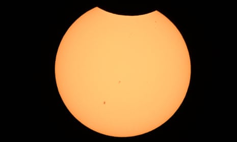 The moon begins crossing in front of the sun in Albuquerque, New Mexico on Saturday.
