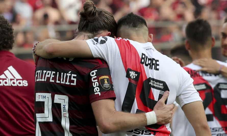 Filipe Luis of Brazil’s Flamengo, left, embraces Rafael Borre of Argentina’s River Plate.