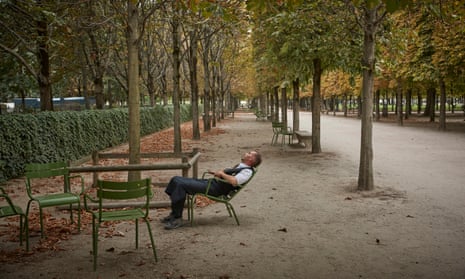 A waiter sleeps in the shade of the Tuileries Garden as a heatwave gripped Paris, France, in 2020.