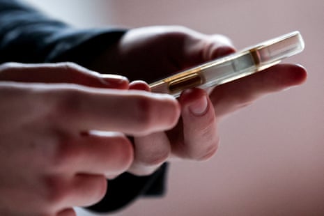 Teenager holds a mobile phone