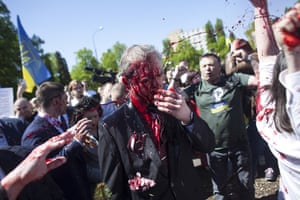 Russian ambassador to Poland, Sergey Andreev, is covered with red paint thrown at him by people protesting against the war in Ukraine