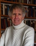 Portrait of Mensun Bound in front of a bookshelf