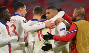 Kylian Mbappe is mobbed by teammates after scoring the third.