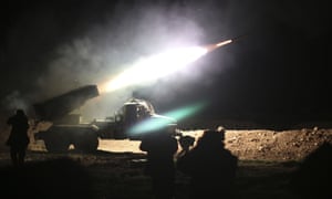 Syrian army soldiers fire a rocket at Isis positions in Raqqa, Syria.