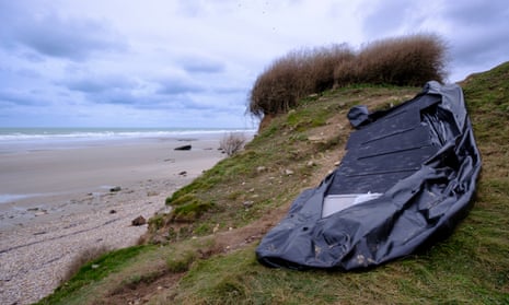 A torn dinghy sits in the dunes on 26 November 2021 in Wimereux, Pas-de-Calais, France.