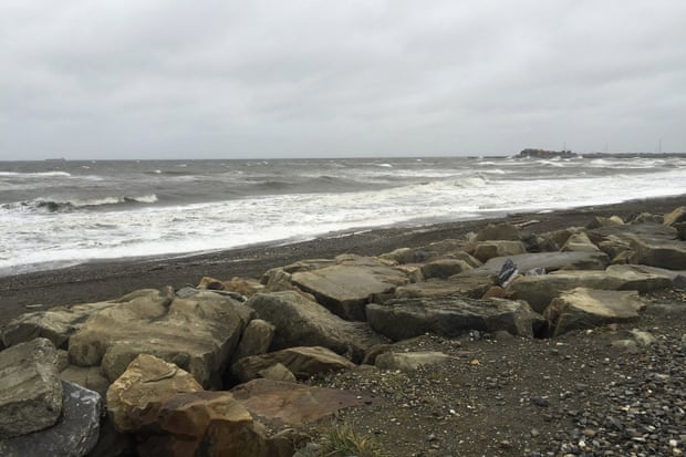 Swells rise up in the Bering Sea as they head toward the rocky shore.