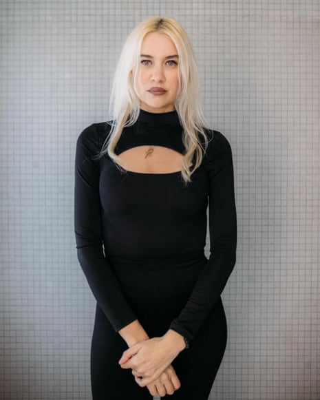 Olivia Nervo, a woman with long blond hair dressed in a black dress