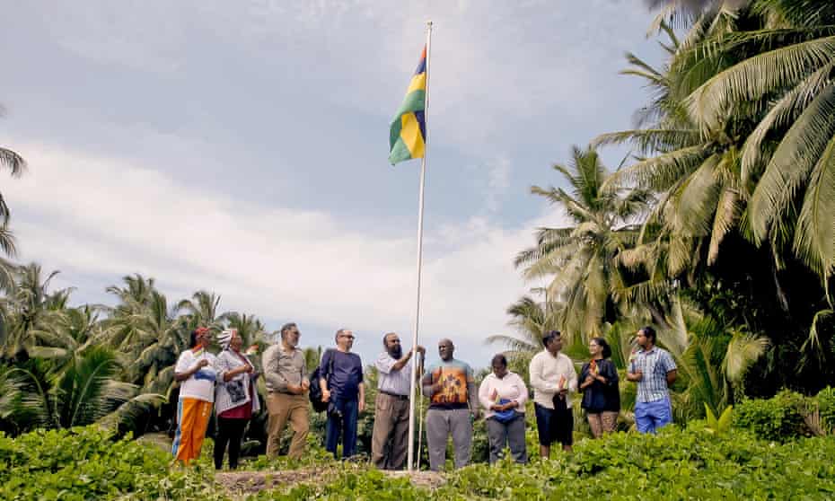 Officials raised the Mauritian flag above an atoll on the Chagos Islands, pictured, and sang the national anthem in a ceremony on Monday.