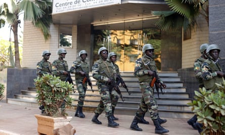 Soldiers patrol outside the hotel in Bamako that was attacked by Islamic extremists.