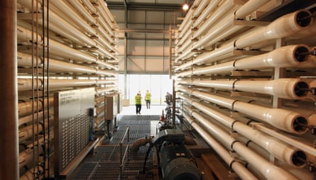 Workers stand near pressure vessels at Thames Water's desalination plant.