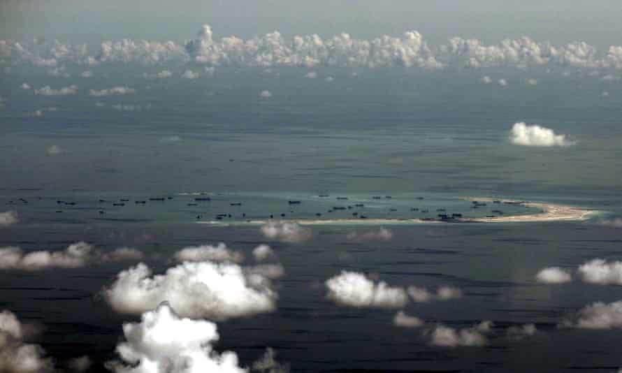 An aerial file photo taken though a glass window of a Philippine military plane shows ongoing land reclamation by China on Mischief Reef in the Spratly Islands in May 2015.