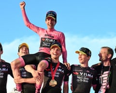 Simon Yates is held aloft by his Visma-Lease a Bike teammates.