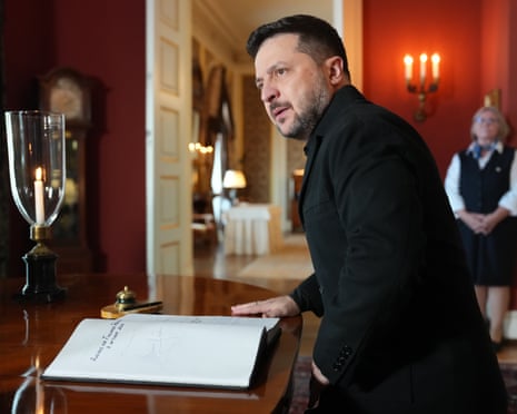 Volodymyr Zelensky signs a guestbook at Norway’s Royal Palace in Oslo
