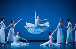 Leaping dancer framed by other ballerinas