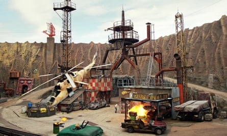 A movie set, prepared for an action scene with helicopter, trucks and cars at Filmpark Babelsberg, Germany