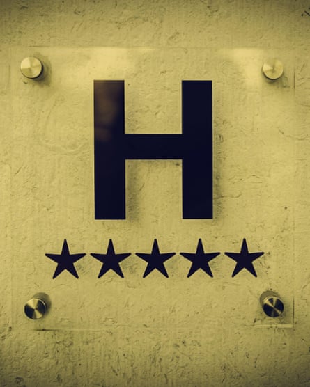 An ‘H’ hotel sign with five stars underneath