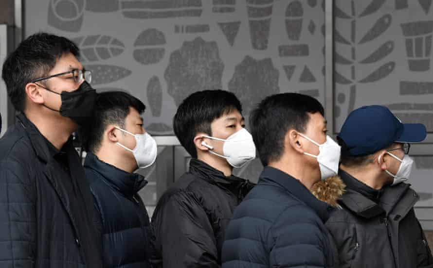 Workers queue for coronavirus tests at a temporary facility in Seoul in South Korea