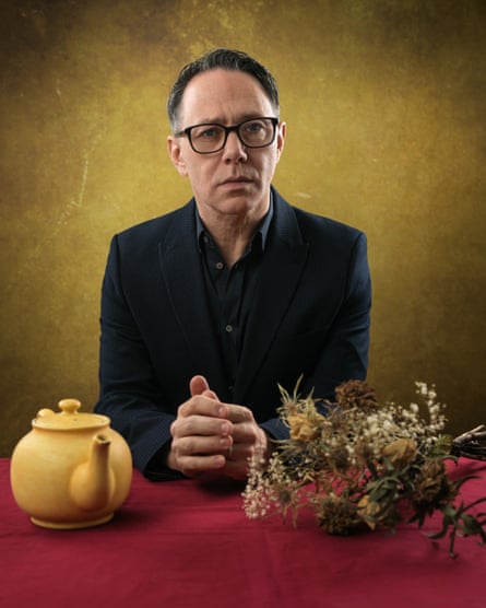 Reece Shearsmith sitting in front of a table