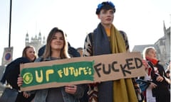 Two students hold a sign ‘Our Future’s F**ked’ at a protest against the scrapping of student maintenance grants in London.
