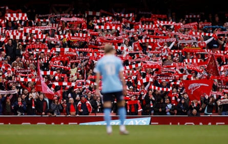 Arsenal fans with scarves watching on during the game against Manchester City