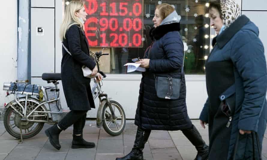 People walk past a currency exchange office in Moscow earlier this year.