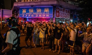 Residents of Whampoa join protesters outside the MTR station and shout at police after one protester was arrested on Saturday.