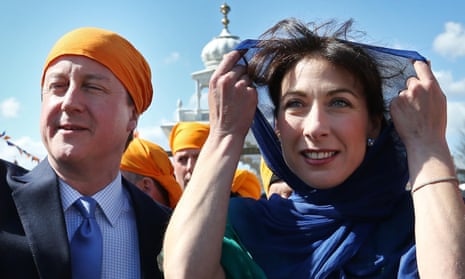 Prime Minister David Cameron and his wife Samantha take part the Vaisakhi Nagar Kirtan procession at Guru Nanak Darbar Gurdwara in Gravesend, England.