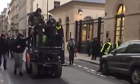 A grab from footage of protesters on a forklift drive used to ram through the entrance to a ministry annexe housing a government spokesman.